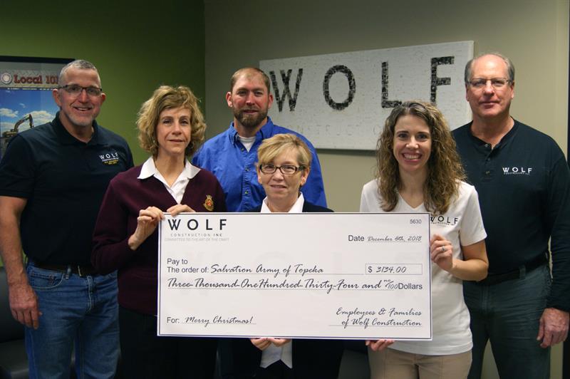 Wolf presents check to Topeka Salvation Army.